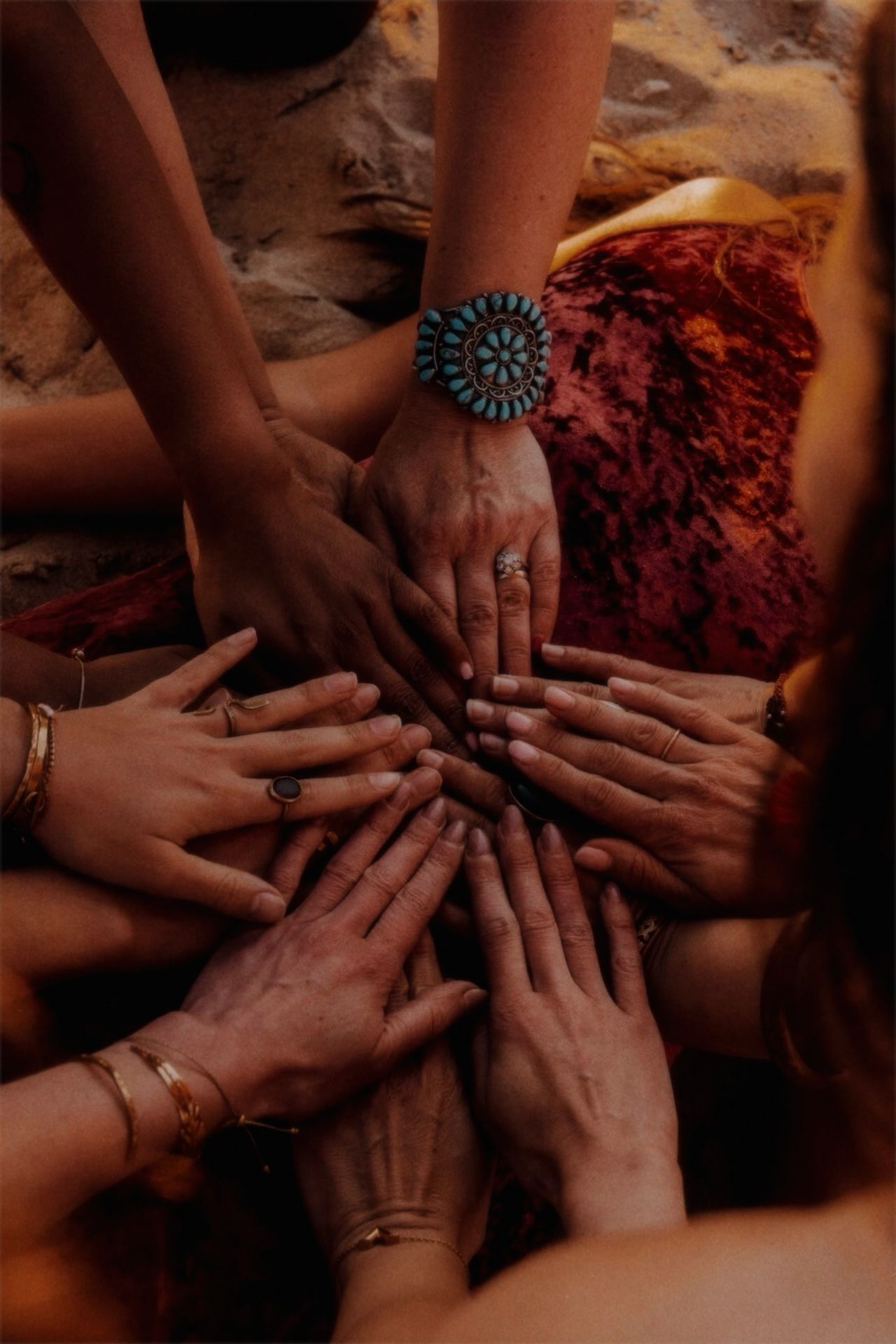 Women's hands held in circle